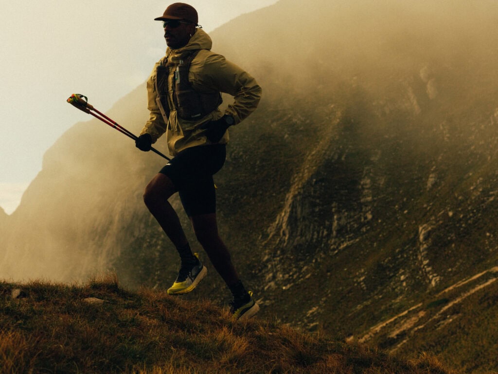 Trail runner climbing rocky mountain trail KEEN outdoor running shoes